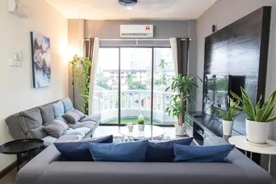 a living room with a couch and a large window at Omar's Place 1 in Kuala Lumpur
