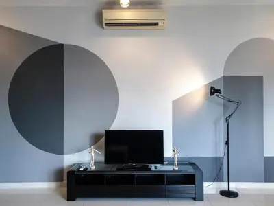 a living room with a television and a microphone at Regalia Residence The Sky Pool Suite in Kuala Lumpur