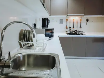 a kitchen with a sink and a counter top at Regalia Residence The Sky Pool Suite in Kuala Lumpur
