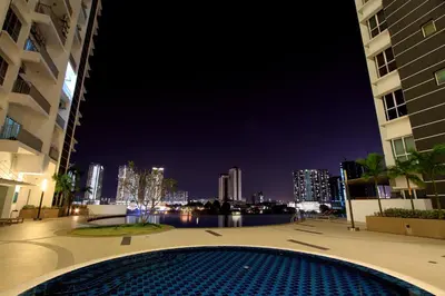 a swimming pool at night with a view of the city at Zeta Desky in Kuala Lumpur