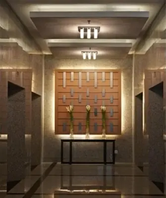 a room with two vases with flowers on a table at Premiera Hotel Kuala Lumpur in Kuala Lumpur