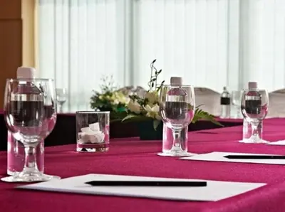 a table with wine glasses on a purple table cloth at Premiera Hotel Kuala Lumpur in Kuala Lumpur