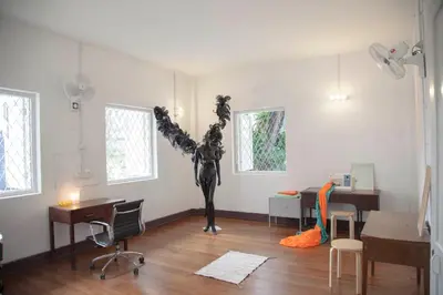 a room with a statue in the middle of a room at YWCA Kuala Lumpur in Kuala Lumpur