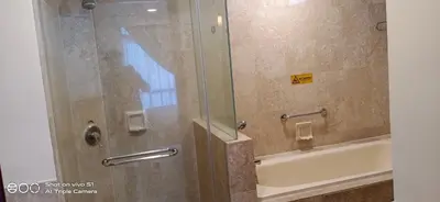 a bathroom with a shower with a tub and a toilet at KL Times Square Apartment in Kuala Lumpur