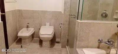 a bathroom with a toilet and a sink and a shower at KL Times Square Apartment in Kuala Lumpur