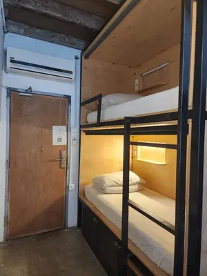 a couple of bunk beds in a room with a door at Mingle Highstreet - CoWorking Hub in Kuala Lumpur