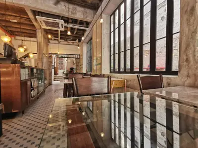 a restaurant with a glass table and leather chairs at Mingle Highstreet - CoWorking Hub in Kuala Lumpur