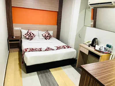 a hotel room with a bed and a telephone at Sky Hotel @ Pudu in Kuala Lumpur