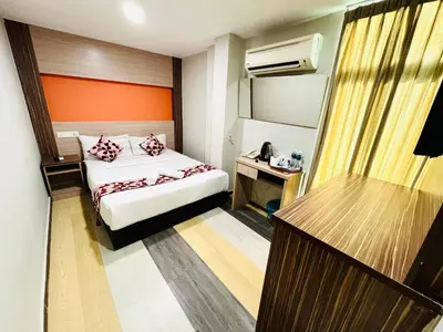 a small hotel room with a bed and a desk at Sky Hotel @ Pudu in Kuala Lumpur