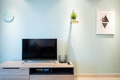 a flat screen tv sitting on top of a table at 3 Rooms Elegant Minimalist Design Setapak 15min KLCC in Kuala Lumpur