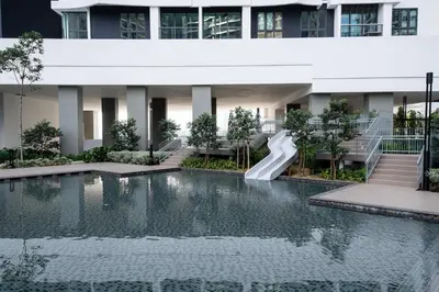 a swimming pool with a slide in front of a building at 3 Rooms Elegant Minimalist Design Setapak 15min KLCC in Kuala Lumpur