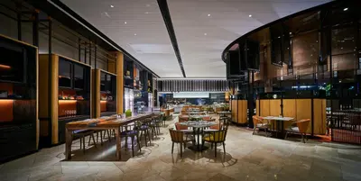 a restaurant with tables and chairs in a room at EQ Kuala Lumpur in Kuala Lumpur