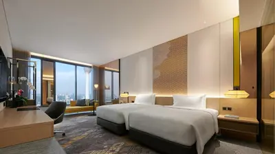 a hotel room with a large bed and a desk at EQ Kuala Lumpur in Kuala Lumpur