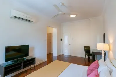 a living room with a bed and a flat screen tv at Wedgewood Residences in Kuala Lumpur