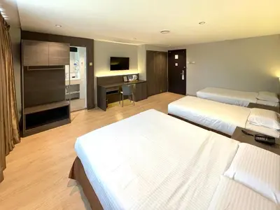 a hotel room with two beds and a piano at Hotel Imperial in Kuala Lumpur