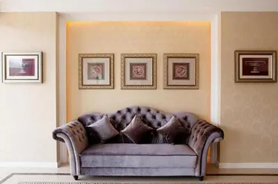 a living room with a couch with pillows on it at Hotel Valenza in Kuala Lumpur