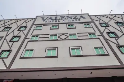 a building with a sign on the side of it at Hotel Valenza in Kuala Lumpur
