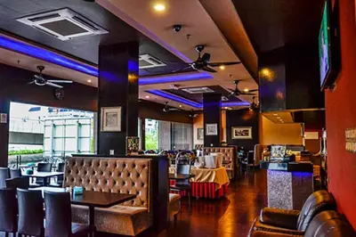 a restaurant with a dining room with tables and chairs at Hotel Valenza in Kuala Lumpur