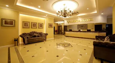 a lobby with couches and a hair salon at Hotel Valenza in Kuala Lumpur