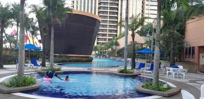 a group of people in a swimming pool at a hotel at Better Residence Suite at Times Square Bukit bintang kl in Kuala Lumpur