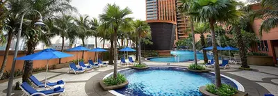 a pool with chairs and umbrellas in a hotel at Better Residence Suite at Times Square Bukit bintang kl in Kuala Lumpur