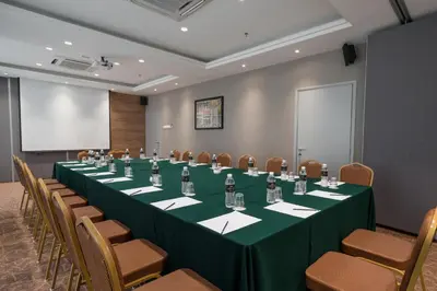 a conference room with a long table and chairs at MPalace Hotel KL in Kuala Lumpur