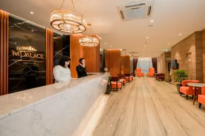 two people standing at a bar in a restaurant at MPalace Hotel KL in Kuala Lumpur