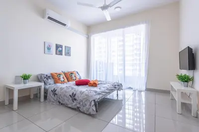 a living room with a couch with pillows and a tv at PV21 Setapak, Wangsamaju, Melawati, 15min to KLCC B36a in Kuala Lumpur