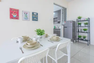 a white table with white chairs and a kitchen at PV21 Setapak, Wangsamaju, Melawati, 15min to KLCC B36a in Kuala Lumpur