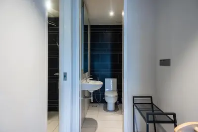 a bathroom with a sink and a toilet at Anggun Residences Luxe in Kuala Lumpur