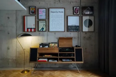 a book shelf with a lamp and pictures on a wall at KLoe Hotel in Kuala Lumpur