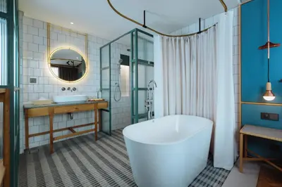 a bathroom with a tub and a sink at KLoe Hotel in Kuala Lumpur