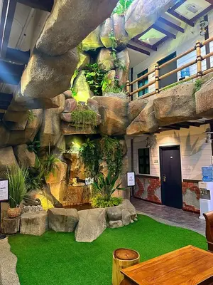 a large indoor aquarium with a rock wall at D'Garden Hotel Kuala Lumpur in Kuala Lumpur