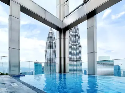 a pool on the roof of a building with tall buildings at Tropicana The Residence KLCC in Kuala Lumpur