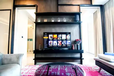 a living room with a couch and a fireplace at Tropicana The Residence KLCC in Kuala Lumpur