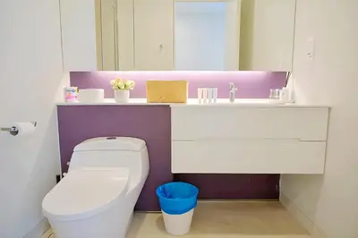 a bathroom with a white toilet and a sink at Tropicana The Residence KLCC in Kuala Lumpur