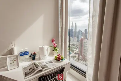 a room with a window with a view of a city at EXPRESSIONZ KLCC by Gsuites in Kuala Lumpur