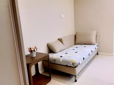 a small room with a couch and a table at Dorsett Residences Sri Hartamas in Kuala Lumpur