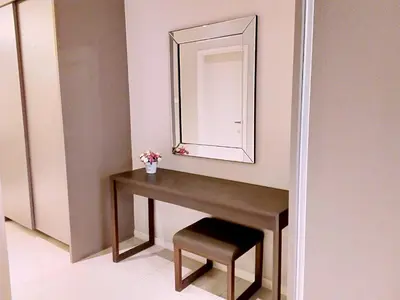a bathroom with a vanity with a mirror and a stool at Dorsett Residences Sri Hartamas in Kuala Lumpur