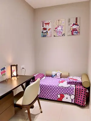 a bedroom with a desk and a bed with a table and chairs at Dorsett Residences Sri Hartamas in Kuala Lumpur