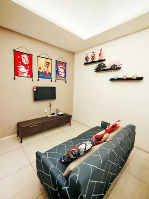 a living room with a couch and a tv at Dorsett Residences Sri Hartamas in Kuala Lumpur