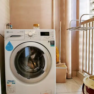 a white washing machine sitting in a room at SKY POOL Luxury Suite 2-4Pax at KL City in Kuala Lumpur