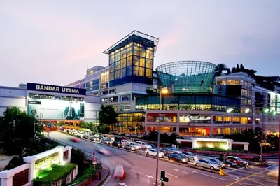 a large building with cars parked in a parking lot at SKY POOL Luxury Suite 2-4Pax at KL City in Kuala Lumpur