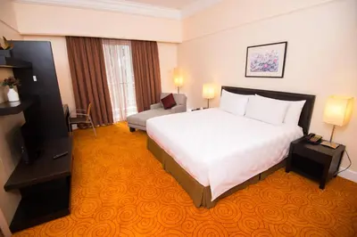 a hotel room with a bed and a television at Perdana Kuala Lumpur City Centre in Kuala Lumpur