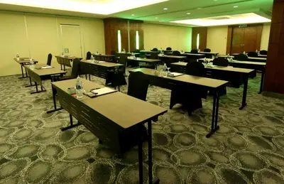 a dining room with tables and chairs in a room at Perdana Kuala Lumpur City Centre in Kuala Lumpur
