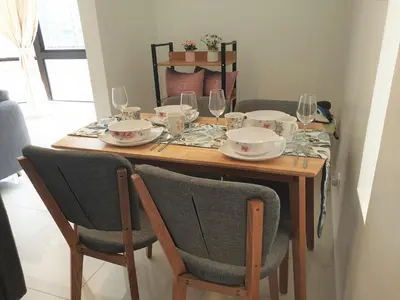 a wooden table with glasses and plates on it at #PERFECT# Location BUKIT BINTANG Apartment in Kuala Lumpur