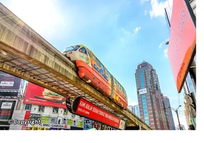 a train on top of a bridge in a city at #PERFECT# Location BUKIT BINTANG Apartment in Kuala Lumpur