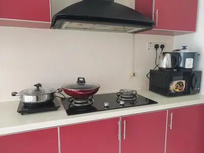 a kitchen with a stove with pots and pans on it at #PERFECT# Location BUKIT BINTANG Apartment in Kuala Lumpur