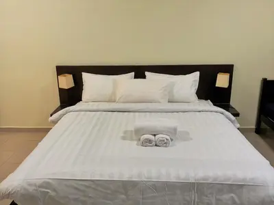 a bed with two towels and two pillows on it at #PERFECT# Location BUKIT BINTANG Apartment in Kuala Lumpur