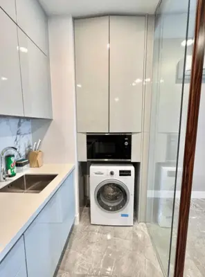 a kitchen with a washing machine and a sink at The Platinum KLCC 2 in Kuala Lumpur